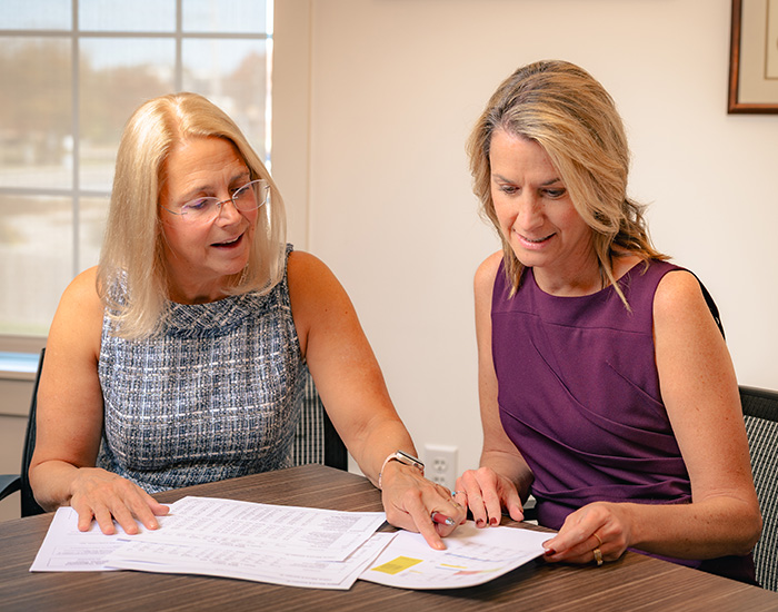 Umbreit, Wileczek & Associates accounts reviewing files together